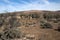 Arid landscape with abandoned shearing shed and quarters in distance