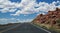 Arid landscape of Arizona. The crumbling sandstone mountains and the highway