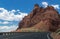 Arid landscape of Arizona. The crumbling sandstone mountains and the highway