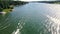 An Ariel dolly of 3 boats in a head on POV with wakes spreading and crossing behind them on a recreational Reservoir Lake