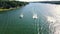 An Ariel dolly of 3 boats in a head on POV with wakes spreading and crossing behind them on a recreational Reservoir Lake