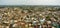 Ariel panorama shot of a city with large number of small houses with greenery around it