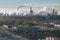 ariel panoramic view of city with huge factory with smoking chimneys in the background