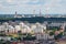 Ariel panoramic view of city and skyscrapers with a huge factory with smoking chimneys in the background