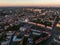 Ariel panoramic view of city and skyscrapers with a huge factory with smoking chimneys in the background