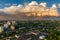 Ariel panoramic view of city and skyscrapers with a huge factory with smoking chimneys in the background