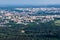 Ariel panoramic view of city and skyscrapers with a huge factory with smoking chimneys in the background