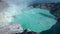 Ariel reveal shot of the acidic crater lake in Mount Ijen in East Java