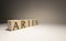 Aries word on wooden cubes on white background