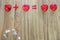 Arithmetic of love. Example with hearts on a wooden background