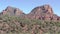 Arizona, Sedona, A pan across a red rock formation in Sedona with trees and houses