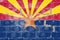 Arizona state flag of USA with orange star in blue, red and yellow colors for Independence Day against the background of a brick