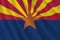 Arizona US state flag with big folds waving close up under the studio light indoors. The official symbols and colors in