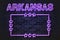 Arkansas US State glowing violet neon letters and starred frame on a black brick wall