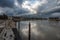 Arles, Provence, France, View from the banks of the River Rhone with a promenade and dark rainy clouds