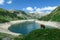 Arlhoehe - A cow grazing at the lake side in high Alps