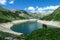 Arlhoehe - A cow grazing at the lake side in high Alps