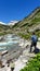 Arlhoehe - A man enjoying a cascading waterfall in the Alps