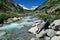 Arlhoehe - A man enjoying a cascading waterfall in the Alps