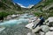 Arlhoehe - A man enjoying a cascading waterfall in the Alps