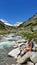 Arlhoehe - A woman enjoying a cascading waterfall in the Alps