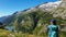 Arlhoehe - A woman sitting at the side of a mountain and enjoying the view on a lake below