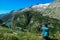 Arlhoehe - A woman sitting at the side of a mountain and enjoying the view on a lake below