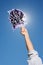 Arm of a cheerleader holding pom-pom