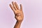 Arm and hand of black middle age woman over pink isolated background counting number 4 showing four fingers