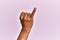 Arm and hand of black middle age woman over pink isolated background showing little finger as pinky promise commitment, number one