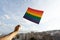 Arm waving and holding pride rainbow flag, support LGBTQ community. Sexual identity for equal social discrimination for freedom of