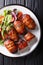 Armadillo eggs are a classic Texas BBQ staple served with salad close up on a plate. Vertical top view