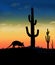 An armadillo is seen wandering in the desert at sunset