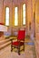 Armchair with red fabric in an ancient Romanesque church