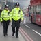 An armed police officer stands guard near Westminster Bridge an