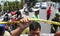 Armed police stan guard behind police line