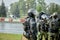 Armed police stand in the pouring rain to disperse the protesters