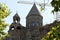 Armenia, Echmiadzin, September 2021.  The arrow of a construction crane and the dome of the Armenian church.