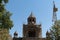 Armenia, Echmiadzin, September 2021. A reconstructed cathedral and a construction crane among the trees.