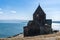 Armenia, Lake Sevan, September 2021. Medieval Armenian temple on the background of the lake.