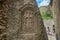 Armenia,monastery Geghard - 2017,June 12.Armenian cross stone khachkar in the wall of ancient monastery.