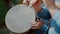 Armenian boy drummer's hands playing dhol drum in traditional armenian wear during the harvest festival