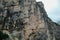 Armentarola - A close up view on a massive, high and desolated mountain wall in Italian Dolomites. The wall has sandy color