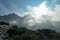 Armentarola - A view on a high and sharp mountains towering above the ground level. The peaks are shrouded with a few clouds