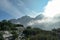 Armentarola - A view on a high and sharp mountains towering above the ground level. The peaks are shrouded with a few clouds