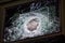 Armored glass after of a direct hit from an automatic weapon. Safety glass after being hit by a bullet. Bulletproof