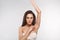 Armpit epilation, lacer hair removal. Young woman holding her arms up and showing clean underarms, depilation smooth clear skin .B