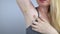 Armpit rash. Underarm skin irritation. Blonde girl shows irritation on the skin after using a razor, trimmer, deodorant or antiper