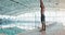 Arms, stretching and black man at swimming pool for exercise, training or water sports in gym. Body, fitness and health