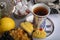 Armudu white cup with tea, with blue print in the form of a buta on a white saucer with a blue frame and biscuits.